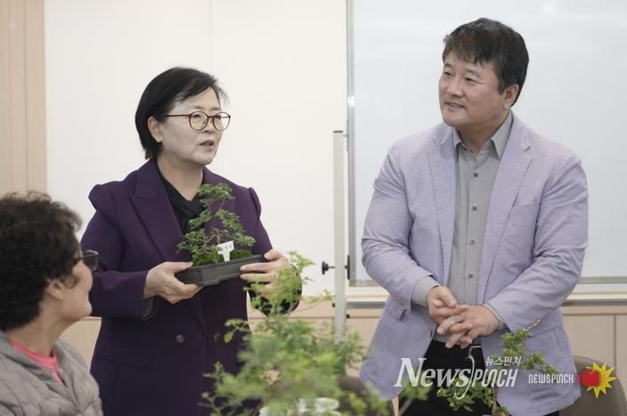 이순희 강북구청장(왼쪽 첫 번째)이 화계중학교를 방문해 최중호 교장과 함께 평생학습 프로그램 ‘국화분재 수업’에 참여한 주민들과 대화를 나누고 있다.